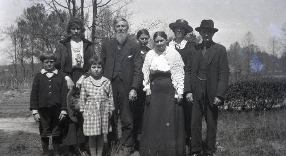 Looking for info on this picture: The negative was in my Grandpa's things- no one in my family knows for sure . My Grandpa was Austin Everett Bodmer (Grandma is Bertha Miller Bodmer). His parents were Charles and Nettie Mae (Whitrock) Bodmer. I think I might see HER (Nettie Mae Whitrock) in the center back, but no one can confirm. Any help would be appreciated. - Donna Bodmer Burke