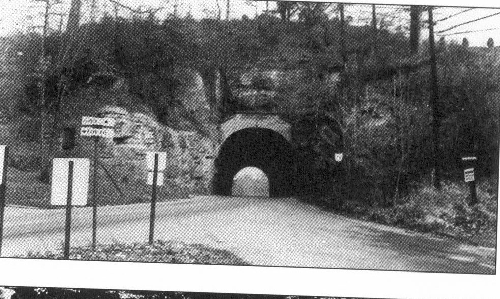 In Ironton, Ohio is the historic OH 75 tunnel. Constructed in 1866 by Dr. B.F. Cory as a way for horses and buggies to access the iron furnaces in rural Lawrence County, the tunnel was bored through sandstone and limestone. In 1915, the tunnel was enlarged by the Mahlbe Brothers to 30-feet wide and was enough to accommodate two automobile lanes. It was closed and sealed in 1960 when a four-lane bypass was constructed to the immediate west as part of the OH 93 realignment and US 52 freeway construction development. 