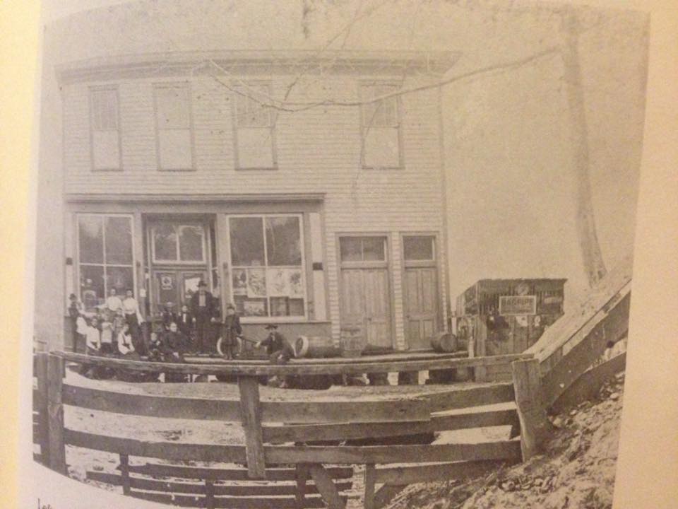 Photo courtesy of Carol Taylor Craft Store and post office at Willow Wood around 1900 William D. Holschuh and his wife Mary, Lilly Holschuh, Lena Holschuh, Mrs Jacob Holschuh, Jacob Holschuh, (the first postmaster) note says 'the lil building on right is a chicken coop' 